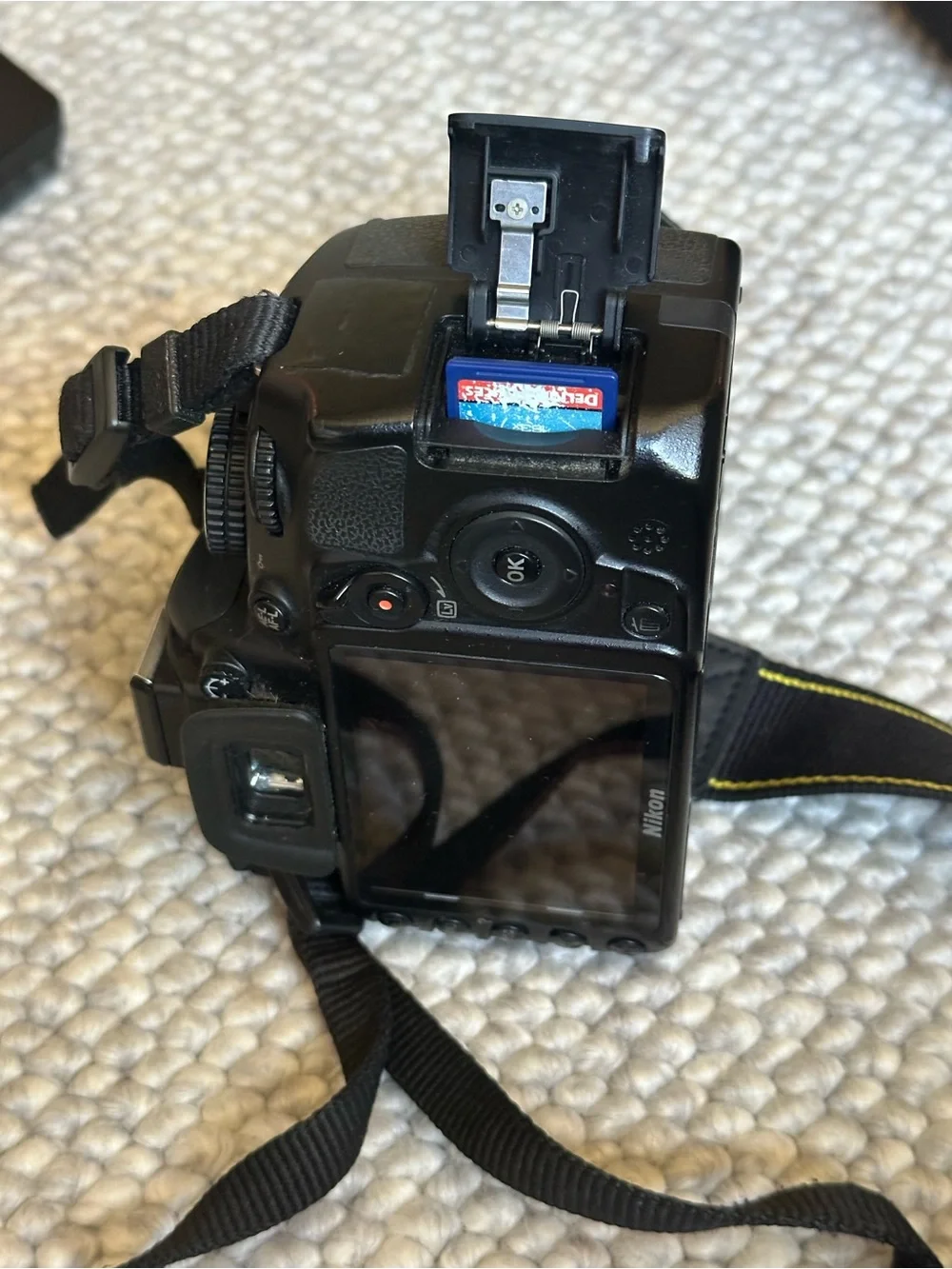 Nikon Black DSLR Camera with Black Lens and Strap